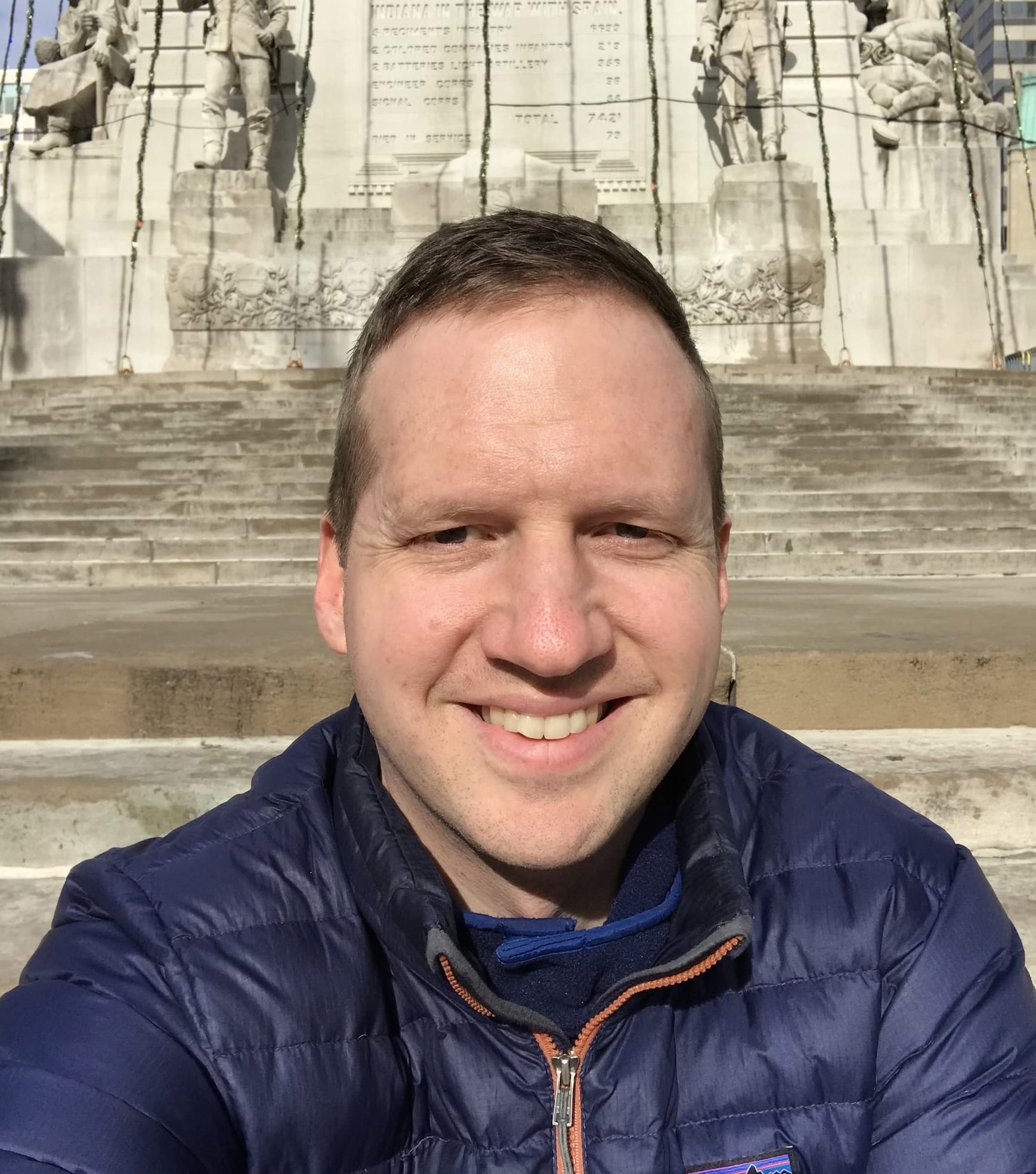 close-up of Bert Witzel outside, with a monument in the background